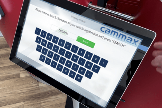 A touchscreen device displays a vehicle registration search with a virtual keyboard and search button.