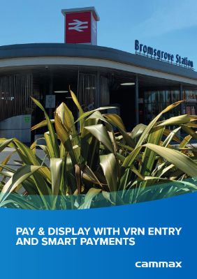 Modern station entrance with large green plant in foreground, clear blue sky above. Text reads "Pay & Display with VRN Entry and Smart Payments."